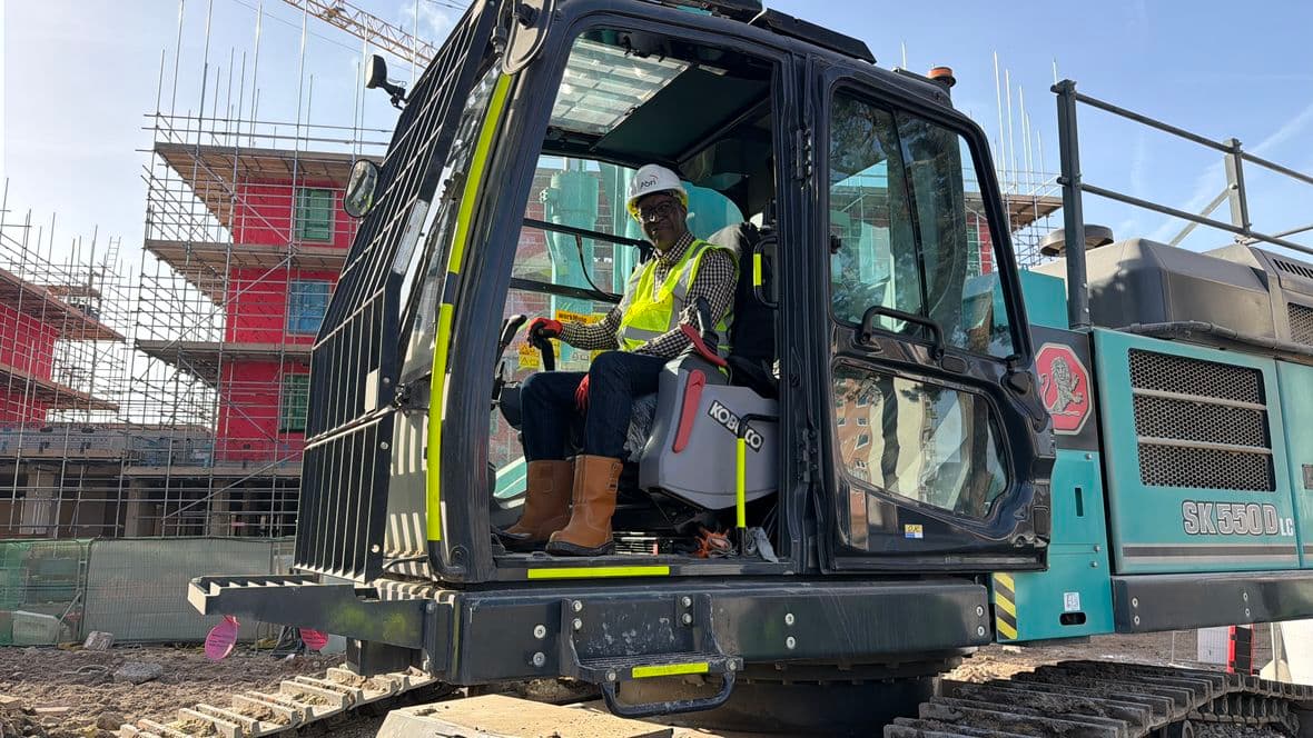Former resident Davine Bwalya in cab of digger (Winwood)